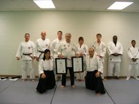 Sensei Little receiving Shichidan and Menkyo Kaiden Certificates